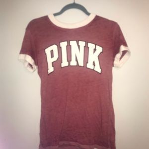 pink shirt with white letters